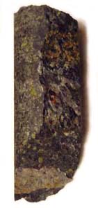 Hewn kimberlite core sample from the  region of Northern , . Green olivine grains and purplish red garnet are visible. The sample is 13 cm (5 inches) long.