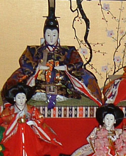 A king doll, with two handmaidens.