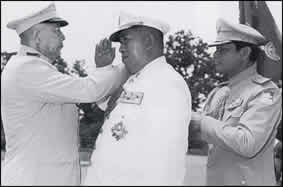 General Ouane Rattikone is decorated by King  in this picture