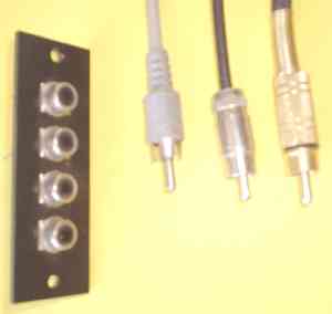 A panel of four RCA jacks, and three RCA (cinch; phono) plugs of various quality