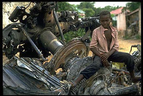A Mogadishu boy straddles the remains of a US Black Hawk helicopter during the 1992-1995 UN peacekeeping operation
