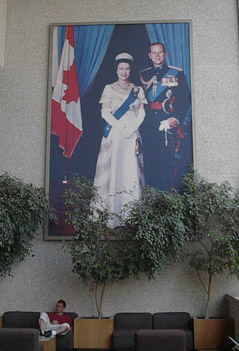 A large portrait of , with , hanging in a Canadian courthouse. Queen Elizabeth is a multiple head of state, and is Queen of , , ,  , the , and eleven  (1952-present)