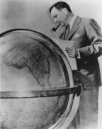 Juan Trippe surveying his office globe.