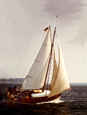 A gaff-rigged cutter flying a mainsail, staysail and genoa 