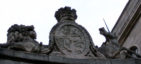 Royal Coat of Arms after the Act of Union 1800 Displayed over the   in Dublin. These arms of dominion are similar to the royal arms before the union inasmuch as the arms of Ireland (the harp) form one quarter of the shield with the remaining quarters referring to the kings other realms (ie: England, Scotland and Hanover).