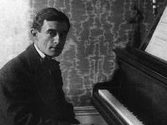 Maurice Ravel by the piano