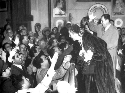 Eva and Juan Pern with a crowd of supporters (note their portraits in the background).