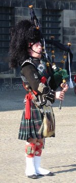 A bagpiper in military uniform, complete with hair sporran.