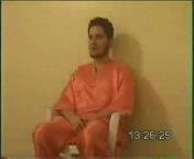 Nick Berg seated on a  during the first moments of the video.