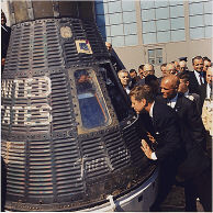JFK looks at the space craft , the spacecraft that made three earth orbits, piloted by astronaut .