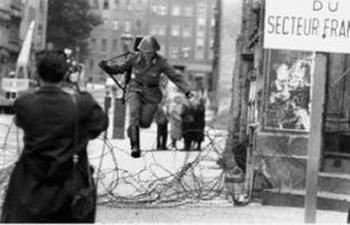East German border guard  leaps into the French Sector of  over barbed wire on August 15, 1961