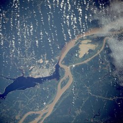 , the largest city on the Amazon, as seen from a  satellite image, surrounded by the muddy Amazon River and the dark .
