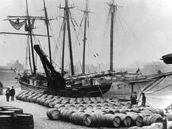 Port wine from Oporto being unloaded on a London Docks quayside, circa 1909