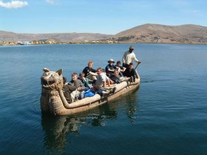 Tourists aboard a "totora boat" made of reeds on Lake Titicaca.