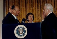 Vice President Ford is sworn in as the 38th President of the United States by Chief Justice  as  looks on.