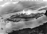 Japanese planes attacking Battleship Row, as seen from the southwest.  is in the center of the picture, and Battleship row is behind the island