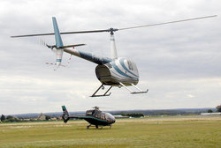 A helicopter twin-bladed main rotor, mounted on a pylon (Robinson R44)