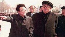 Kim Jong-il (left), with his father .