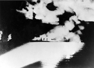 Quincy caught in Japanese searchlights, moments before sinking off Savo Island with great loss of life,  .