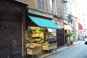 A  in central Milan with a sign in Milanese, the local dialect, claiming to be 'the oldest greengrocer of Milan' (l'ortoln pŝee vcc de Milan)