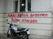 May Day graffiti in Berlin. The text reads, ": Cars burning, cops dying", a typical exaggeration.