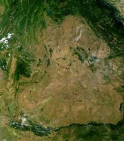 A satellite image of Isan: the borders with  and  can be seen due to the greater deforestation within Isan