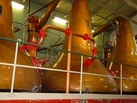 The wash, 5%–7% , is distilled in  pot stills like these at the Lagavulin distillery, boosting the alcohol content to 60%–80%.