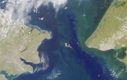 Satellite photo of the Bering Strait, with the Diomede Islands at center.