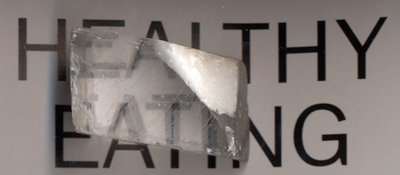 A calcite crystal laid upon a paper with some letters showing the double refraction