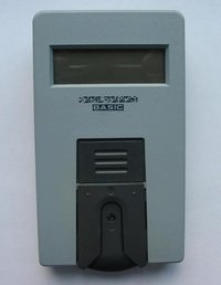 An older style portable blood glucose meter. A blood sample is applied to an inserted strip (see image below) and color changes caused by reaction with blood glucose are measured by the meter.