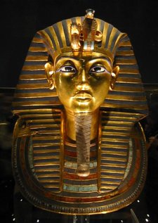 Gold burial mask of Tutankhamun found in the young king's tomb, excavated by  in 1922. The mask appears in the background of the National Geographic forensic image (below left).