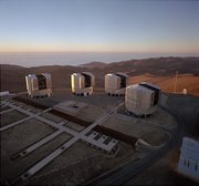 The four telescopes of the European Southern Observatory Paranal site. The VLTI (Very Large Telescope Interferometer) building is the low structure in front of the telescopes. Image courtesy of the .