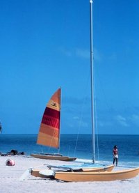 Two Hobie catamarans, showing the typical Hobie raised platform joining the two hulls, and tall mast.