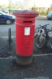 Customers deposit mail in red collection boxes for the Royal Mail to sort and deliver it.  This one bears the monogram ER for Edvardvs Rex or .
