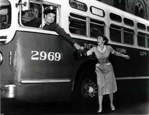 Jackie Gleason and  in a staged publicity shot for .  While Gleason's Ralph Kramden was a bus driver, he was never seen actually driving a bus in the series.