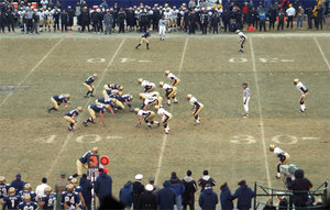 Football players line up before the play during the 2002 annual .  , on the left, has possession.