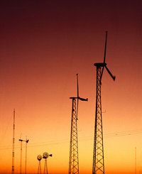 High-efficiency wind turbines (foreground) win out over traditional windmills (background) in most new installations.