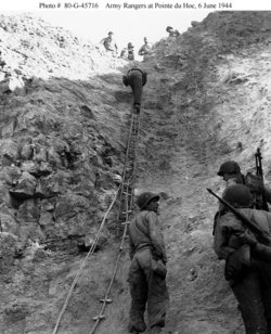  demonstrate the rope ladders they used to scale Pointe du Hoc