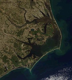 North Carolina's Outer Banks separating the Atlantic Ocean (east) from Albemarle Sound (north) and Pamlico Sound (south). Orbital photo courtesy NASA.