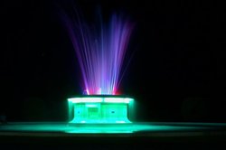An ornamental lit fountain photographed at night for about 6 seconds.