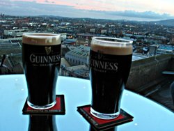 Two "perfectly poured" Guinness beers atop the Guinness factory, overlooking the city of .