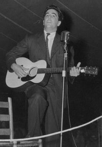 Lomax playing guitar, sometime between 1938 and 1950
