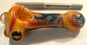 A hand-blown glass pipe (sitting next to a ballpoint pen for size reference)