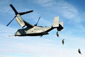 U.S. Marines jump from an Osprey.