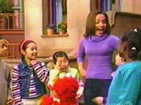 Gabby, Elmo, and some kids sing the Kitten-Bird-Cow song, in front of 123 Sesame Street.