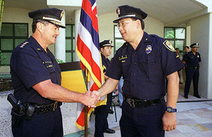 Police Chief Lee Donohue on the left honors Police Chaplain Andrew Kikuta during a June 28, 2000 ceremony at police headquarters.