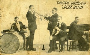 Shown are (left to right) Tony Sbarbaro (aka Tony Spargo) on drums; Edwin "Daddy" Edwards on trombone; D. James "Nick" LaRocca on cornet; Larry Shields on clarinet, and Henry Ragas on piano. From a 1918 promotional postcard while the band was playing at Reisenweber's Cafe in New York City.