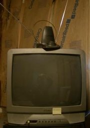 A television with a VHF "rabbit ears" antenna and a loop UHF antenna.