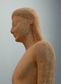 Side view of a kouros in the Thebes Archaeological Museum, showing the characteristic archaic hairstyle
