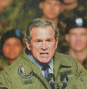 President G.W. Bush in present-day U.S. Army jacket delivering a speech to a military audience